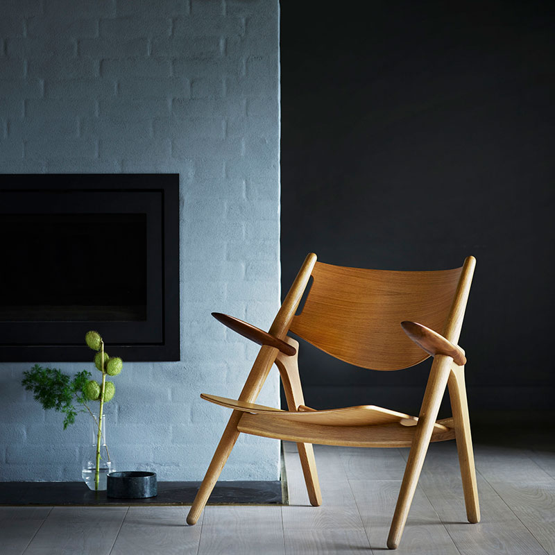 Carl Hansen CH28T Unupholstered Lounge Chair life 2 Olson and Baker - Designer & Contemporary Sofas, Furniture - Olson and Baker showcases original designs from authentic, designer brands. Buy contemporary furniture, lighting, storage, sofas & chairs at Olson + Baker.