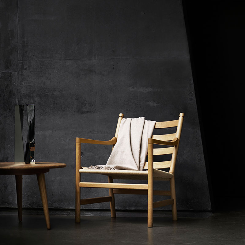 Carl Hansen CH44 Lounge Chair by Hans Wegner life 3 Olson and Baker - Designer & Contemporary Sofas, Furniture - Olson and Baker showcases original designs from authentic, designer brands. Buy contemporary furniture, lighting, storage, sofas & chairs at Olson + Baker.
