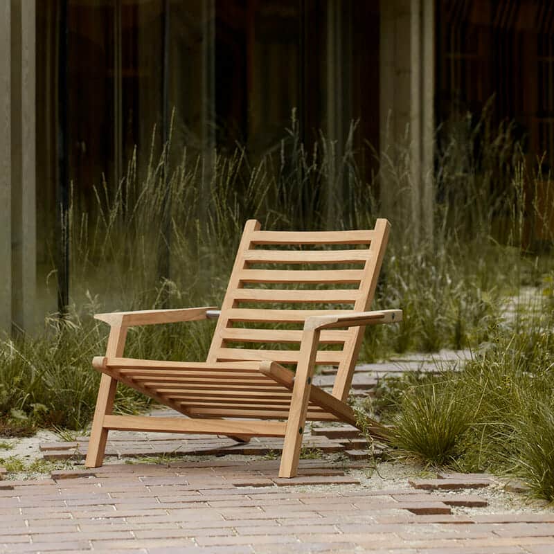 Carl Hansen - AH603 Outdoor Deck Chair - Lifestyle Image 01 Olson and Baker - Designer & Contemporary Sofas, Furniture - Olson and Baker showcases original designs from authentic, designer brands. Buy contemporary furniture, lighting, storage, sofas & chairs at Olson + Baker.