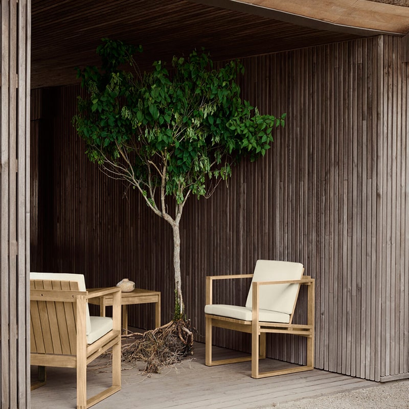 Carl Hansen - BK11 Outdoor Lounge Armchair - Lifestyle Image 02 Olson and Baker - Designer & Contemporary Sofas, Furniture - Olson and Baker showcases original designs from authentic, designer brands. Buy contemporary furniture, lighting, storage, sofas & chairs at Olson + Baker.